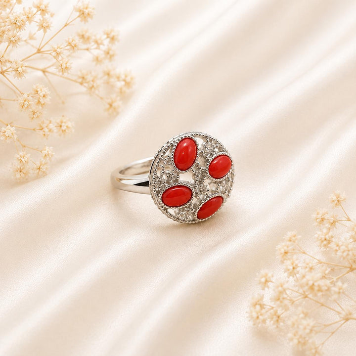 Anello Splendid in Argento 925 rodiato con quattro cabochon di Corallo Rosso Naturale del Mediterraneo, zirconi e misura regolabile.