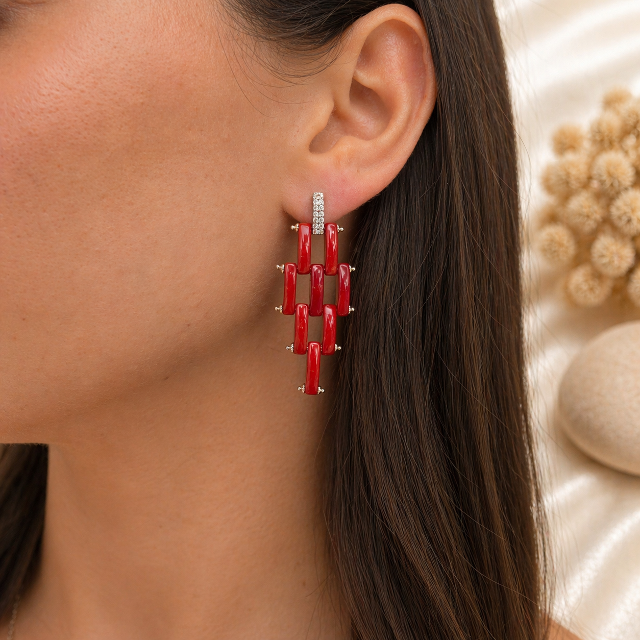 Orecchini modello Cartier indossati in Argento 925 rodiato con fascette di Corallo Rosso Naturale del Mediterraneo e pavé di zirconi.
